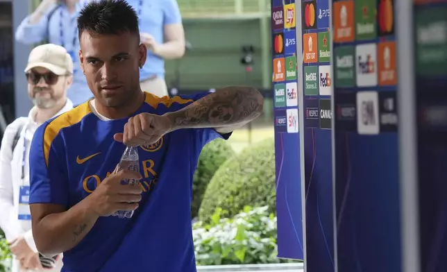 Inter Milan's Lautaro Martinez opens a bottle of water during the Champions League Media Day in view of the Saturday's Champions League final against PSG, at the Inter Milan training center, in Appiano Gentile, Italy, Monday, May 26, 2025. (AP Photo/Antonio Calanni)