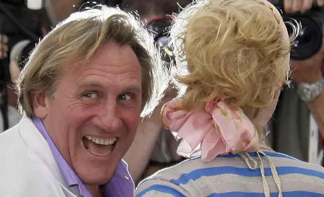 FILE - French actor Gerard Depardieu, left, and Belgian actress Cecile de France pose during a photo call for the film "Quand J'etais Chanteur," at the 59th International film festival in Cannes, southern France, on May 26, 2006. (AP Photo/Francois Mori, File)