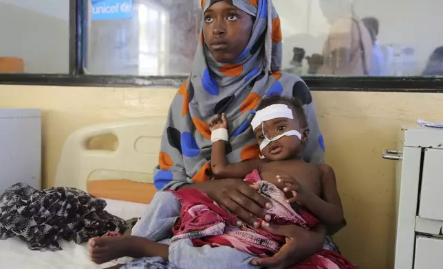 A Somali woman cares for her baby at Banadir Hospital in Mogadishu, Somalia, Wednesday, May 14, 2025. (AP Photo/Farah Abdi Warsameh)