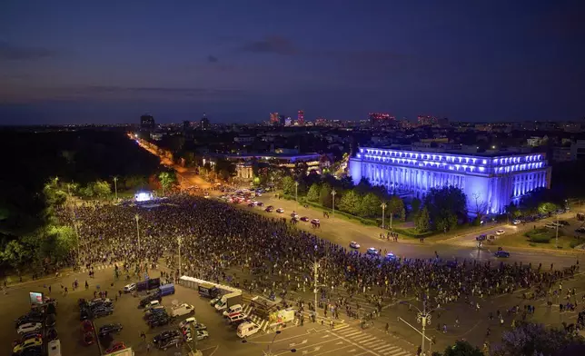 People attend a pro-EU rally outside the government headquarters ahead of the second round of the presidential election redo in Bucharest, Romania, Friday, May 9, 2025. (AP Photo/Vadim Ghirda)