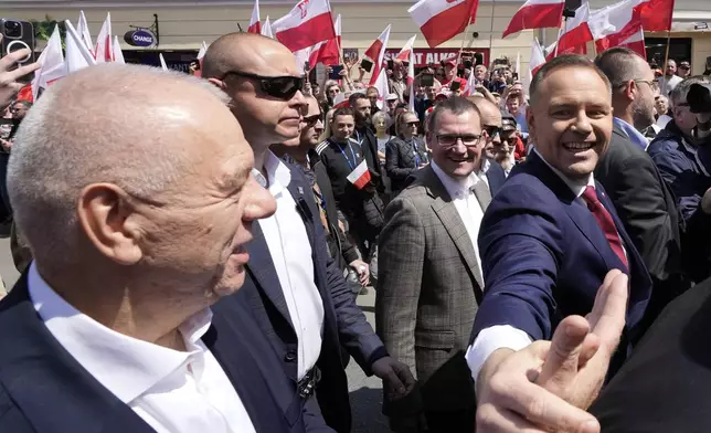 Conservative presidential candidate Karol Nawrocki, front right, takes part in a march one week ahead of a decisive election in Warsaw Poland on Sunday, May 25, 2025. (AP Photo/Czarek Sokolowski)