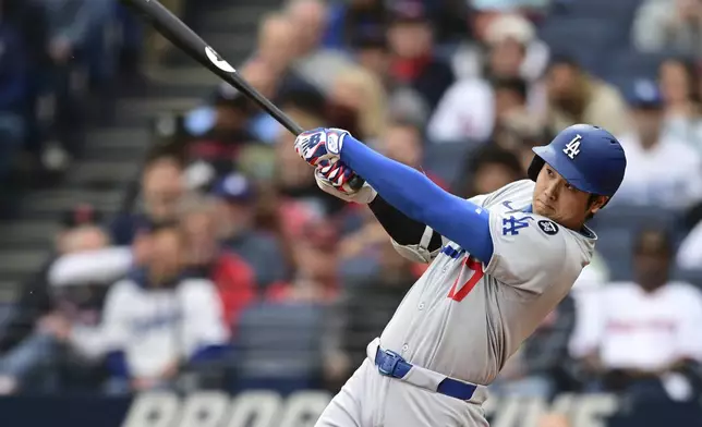 Los Angeles Dodgers' Shohei Ohtani watches his ball after hitting a two run home run off Cleveland Guardians starting pitcher Tanner Bibee during the fourth inning of a baseball game, Tuesday, May 27, 2025, in Cleveland. (AP Photo/David Dermer)