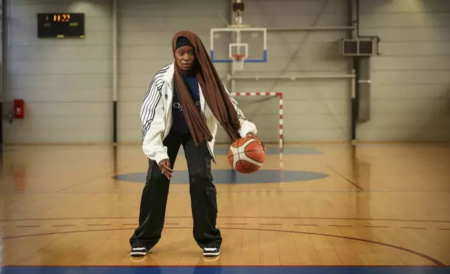 Former player Salimata Sylla poses for a photo before a women's basketball tournament where players can wear a headscarf, in Aubervilliers near Paris, Sunday, April 27, 2025. (AP Photo/Thomas Padilla)