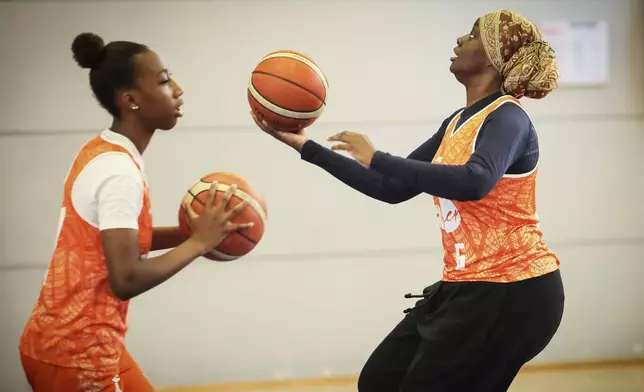 A player wearing a headscarf warms-up before a basketball game, in Aubervilliers near Paris, Sunday, April 27, 2025. (AP Photo/Thomas Padilla)
