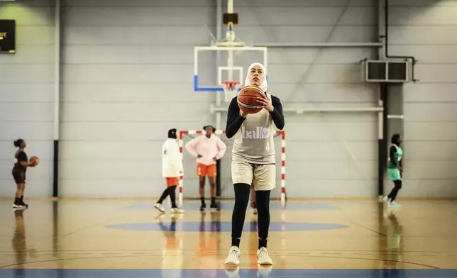 A player wearing a headscarf warms-up before a basketball game, in Aubervilliers near Paris, Sunday, April 27, 2025. (AP Photo/Thomas Padilla)
