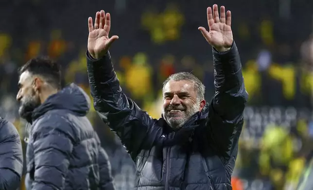 Tottenham coach Ange Postecoglou salutes fans after the Europa League semifinal soccer match between Bodø/Glimt and Tottenham Hotspur at Aspmyra Stadium, Bodo, Norway, Thursday May 8, 2025. (Mats Torbergsen/NTB via AP)