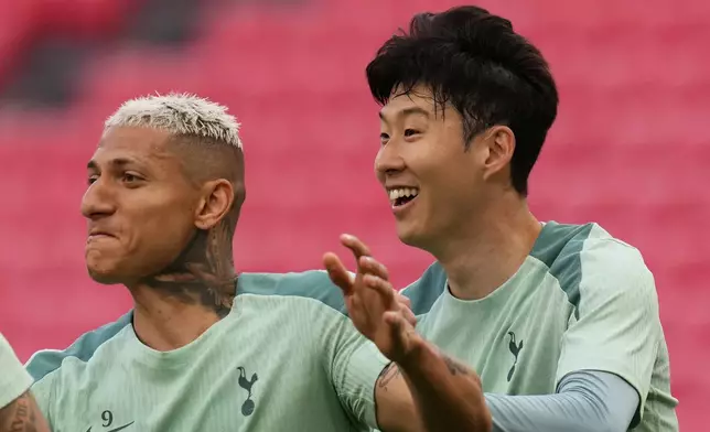 Tottenham's Son Heung-min, right, Tottenham's Richarlison train during a training session ahead of the Europa League final soccer match against Manchester United at the San Mames Stadium in Bilbao, Spain, Tuesday, May 20, 2025. (AP Photo/Manu Fernandez)