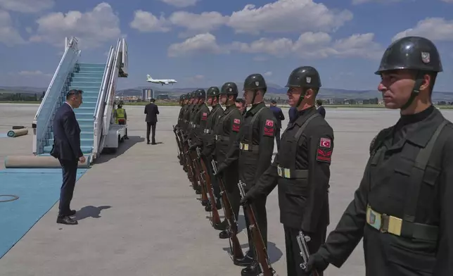 Ukrainian official plane, background, with Ukrainian President Volodymyr Zelenskyy on board lands at Esenboga airport in Ankara, Turkey, Thursday, May 15, 2025. (AP Photo/Evgeniy Maloletka)