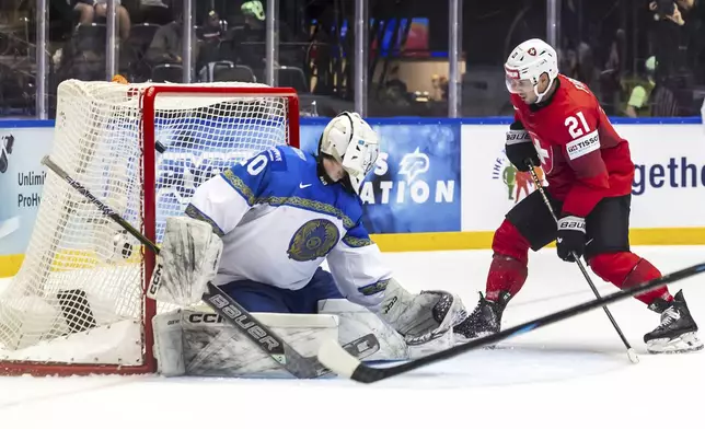 Switzerland's Kevin Fiala, right, scores his side's first goal during the IIHF 2025 Ice Hockey World Championship group B match between Switzerland and Kazakhstan in Herning, Denmark, Tuesday, May 20, 2025. (Salvatore Di Nolfi/Keystone via AP)