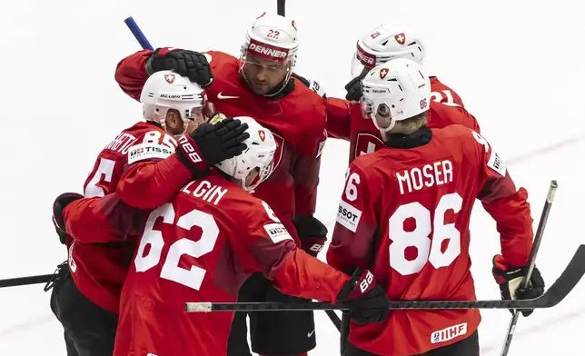 Switzerland's Sven Andrighetto, left, celebrates his side's second goal during the IIHF 2025 Ice Hockey World Championship group B match between Switzerland and Kazakhstan in Herning, Denmark, Tuesday, May 20, 2025. (Salvatore Di Nolfi/Keystone via AP)