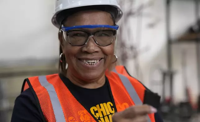 Instructor Kitty Thompson works with students during an Ironworkers Local 63 pre-apprenticeship class Wednesday, March 26, 2025, in Broadview, Ill. (AP Photo/Erin Hooley)