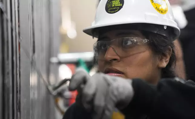 Carol Otarola practices caulking during an Ironworkers Local 63 pre-apprenticeship class Wednesday, March 26, 2025, in Broadview, Ill. (AP Photo/Erin Hooley)