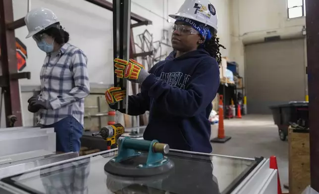 Chyanne Henderson practices putting together a window during an Ironworkers Local 63 pre-apprenticeship class Wednesday, March 26, 2025, in Broadview, Ill. (AP Photo/Erin Hooley)