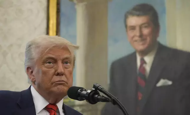 President Donald Trump speaks before Steve Witkoff is sworn as special envoy during a ceremony in the Oval Office of the White House, Tuesday, May 6, 2025, in Washington, with a portrait of former President Ronald Reagan in the background. (AP Photo/Mark Schiefelbein)
