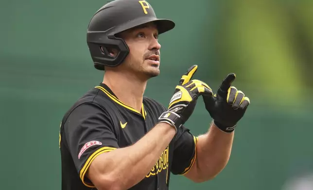 Pittsburgh Pirates' Bryan Reynolds celebrates as he crosses home plate after hitting a solo home run off Chicago Cubs pitcher Colin Rea during the first inning of a baseball game in Pittsburgh, Thursday, May 1, 2025. (AP Photo/Gene J. Puskar)