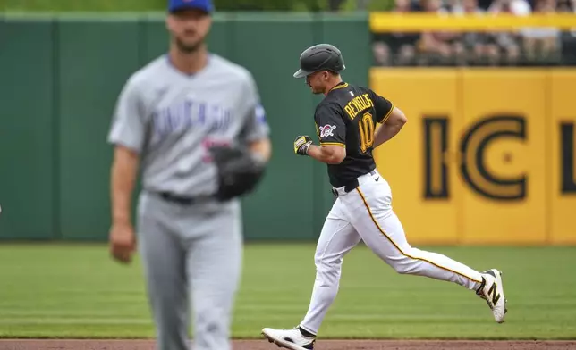Pittsburgh Pirates' Bryan Reynolds (10) rounds the bases after hitting a solo home run off Chicago Cubs pitcher Colin Rea, left, during the first inning of a baseball game in Pittsburgh, Thursday, May 1, 2025. (AP Photo/Gene J. Puskar)
