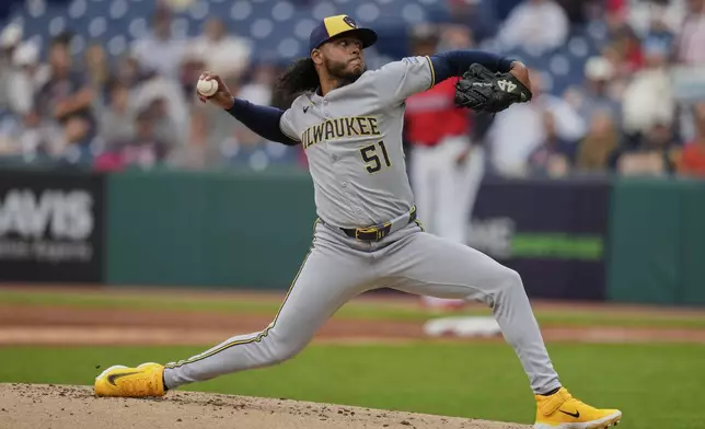 Milwaukee Brewers' Freddy Peralta pitches in the first inning of a baseball game against the Cleveland Guardians in Cleveland, Monday, May 12, 2025. (AP Photo/Sue Ogrocki)