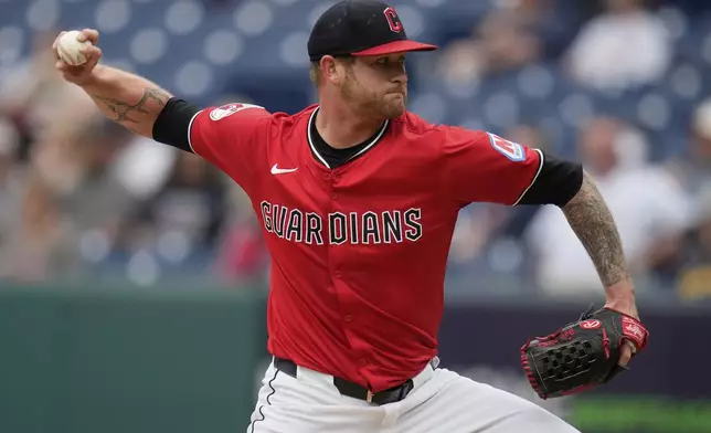 Cleveland Guardians' Ben Lively pitches in the first inning of a baseball game against the Milwaukee Brewers in Cleveland, Monday, May 12, 2025. (AP Photo/Sue Ogrocki)