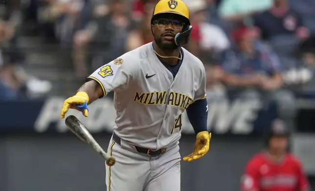 Milwaukee Brewers' Andruw Monasterio (14) drops his bat as he walks in the fourth inning of a baseball game against the Cleveland Guardians in Cleveland, Monday, May 12, 2025. (AP Photo/Sue Ogrocki)
