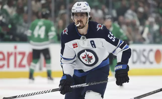 Winnipeg Jets center Mark Scheifele moves to the puck in the first period of Game 4 of a second-round NHL hockey playoff series against the Dallas Stars in Dallas, Tuesday, May 13, 2025. (AP Photo/Gareth Patterson)