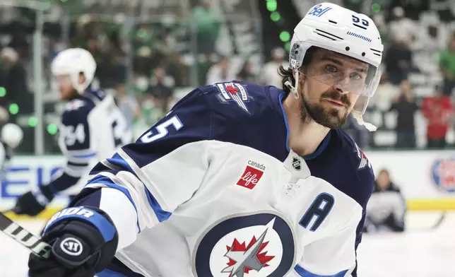 Winnipeg Jets center Mark Scheifele warms up before Game 6 of a second-round NHL hockey playoff series against the Dallas Stars in Dallas, Saturday, May 17, 2025. (AP Photo/Gareth Patterson)