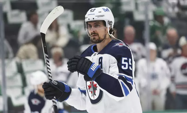 Winnipeg Jets center Mark Scheifele warms up before Game 6 of a second-round NHL hockey playoff series against the Dallas Stars in Dallas, Saturday, May 17, 2025. (AP Photo/Gareth Patterson)