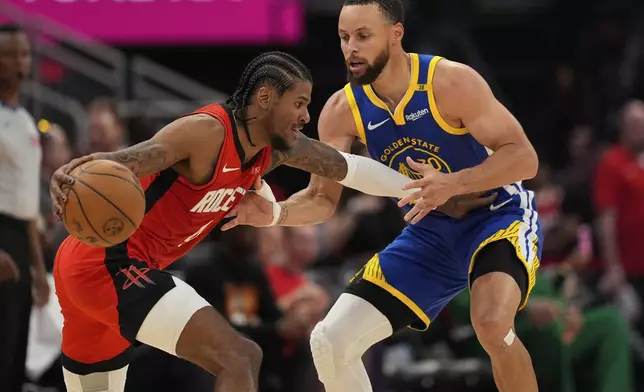 Houston Rockets guard Jalen Green, left, drives on Golden State Warriors guard Stephen Curry during the second half of Game 5 of an NBA basketball first-round playoff series, Wednesday, April 30, 2025, in Houston. (AP Photo/David J. Phillip)