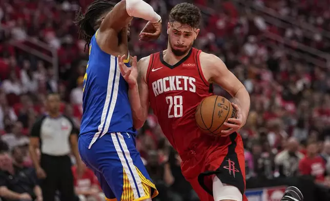 Houston Rockets center Alperen Sengun (28) shoots over Golden State Warriors forward Kevon Looney during the first half of Game 5 of an NBA basketball first-round playoff series, Wednesday, April 30, 2025, in Houston. (AP Photo/David J. Phillip)