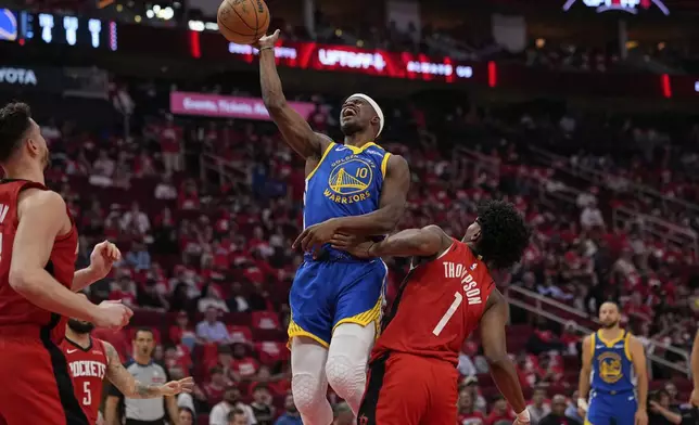 Golden State Warriors forward Jimmy Butler III (10) shoots over Houston Rockets forward Amen Thompson (1) during the second half of Game 5 of an NBA basketball first-round playoff series, Wednesday, April 30, 2025, in Houston. (AP Photo/David J. Phillip)