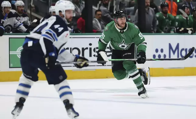 Dallas Stars' Mikko Rantanen (96) skates up ice as Winnipeg Jets' Josh Morrissey (44) defends in the first period of Game 4 of a second-round NHL hockey playoff series in Dallas, Tuesday, May 13, 2025. (AP Photo/Gareth Patterson)