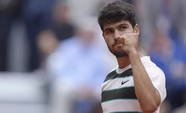 Spain's Carlos Alcaraz reacts after winning a point to Italy's Giulio Zeppieri during their first round match of the French Tennis Open, at the Roland-Garros stadium, in Paris, Monday, May 26, 2025. (AP Photo/Thibault Camus)
