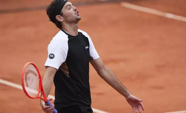 Taylor Fritz of the U.S. reacts as he plays Germany's Daniel Altmaier during their first round match of the French Tennis Open, at the Roland-Garros stadium, in Paris, Monday, May 26, 2025. (AP Photo/Lindsey Wasson)
