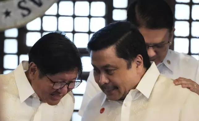 Philippine President Ferdinand Marcos Jr., left, speaks with Senator Jinggoy Estrada, center, beside Senate President Francis Escudero during the presentation of the newly enacted laws to stakeholders at the Malacanang Presidential Palace in Manila, Philippines Thursday, May 22, 2025. (AP Photo/Aaron Favila)