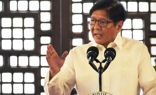 Philippine President Ferdinand Marcos Jr. gestures as he speaks during the presentation of the newly enacted laws to stakeholders at the Malacanang Presidential Palace in Manila, Philippines Thursday, May 22, 2025. (AP Photo/Aaron Favila)