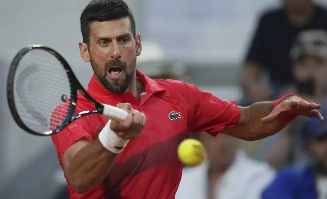 Serbia's Novak Djokovic returns the ball to France's Corentin Moutet during their second round match of the French Tennis Open, at the Roland-Garros stadium, in Paris, Thursday, May 29, 2025. (AP Photo/Christophe Ena)
