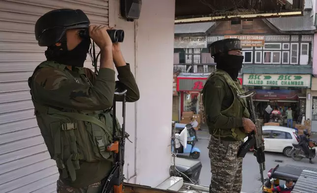 Indian soldiers guard at a market in Srinagar, Indian controlled Kashmir, Tuesday, May 6, 2025. (AP Photo/Mukhtar Khan)