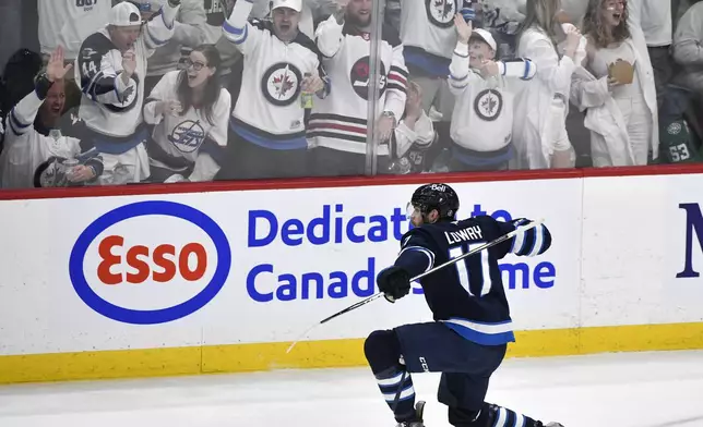 Winnipeg Jets' Adam Lowry (17) celebrates after his goal against the Dallas Stars during the second period of Game 2 of a second-round NHL hockey playoff series in Winnipeg, Manitoba, Friday, May 9, 2025. (Fred Greenslade/The Canadian Press via AP)