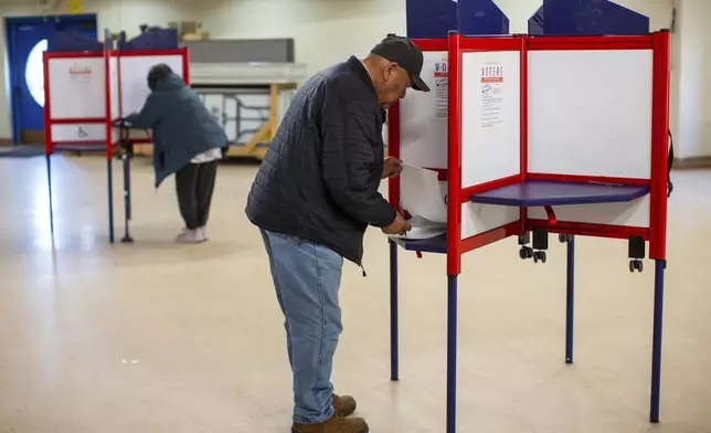 FILE - Voters mark their ballots at a polling station on the Navajo Nation in Fort Defiance, Ariz., on Election Day, Nov. 5, 2024. (AP Photo/Andres Leighton, File)
