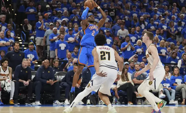 Oklahoma City Thunder guard Shai Gilgeous-Alexander (2) shoots over Denver Nuggets' Jamal Murray (27) and Christian Braun, right, in the second half of Game 7 in the Western Conference semifinals of the NBA basketball playoffs, Sunday, May 18, 2025, in Oklahoma City. (AP Photo/Kyle Phillips)