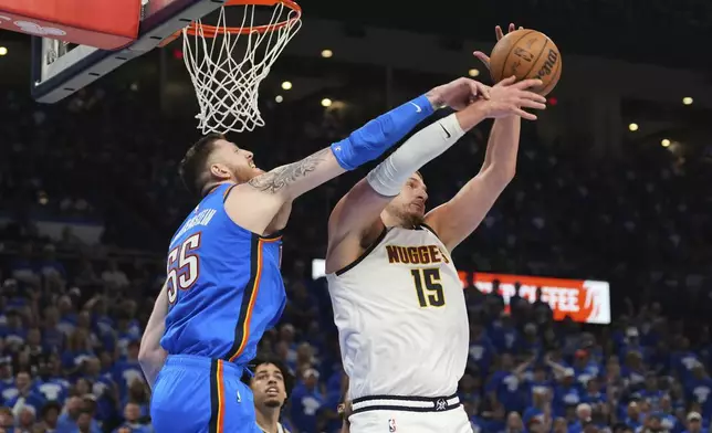Oklahoma City Thunder's Isaiah Hartenstein (55) and Denver Nuggets' Nikola Jokic (15) compete for a rebound in the second half of Game 7 in the Western Conference semifinals of the NBA basketball playoffs, Sunday, May 18, 2025, in Oklahoma City. (AP Photo/Kyle Phillips)