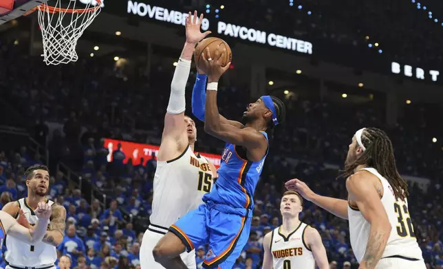 Oklahoma City Thunder guard Shai Gilgeous-Alexander (2) shoots as Denver Nuggets' Nikola Jokic (15) defends in the second half of Game 7 in the Western Conference semifinals of the NBA basketball playoffs, Sunday, May 18, 2025, in Oklahoma City. (AP Photo/Kyle Phillips)