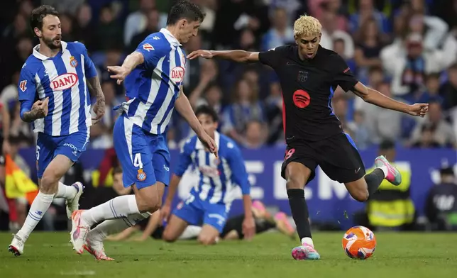 Barcelona's Lamine Yamal scores during a Spanish La Liga soccer match between Espanyol and Barcelona in Barcelona, Spain, Thursday, May 15, 2025. (AP Photo/Jose Breton)