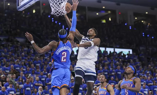 Minnesota Timberwolves guard Anthony Edwards goes up for a basket against Oklahoma City Thunder guard Shai Gilgeous-Alexander (2) during the second half of Game 2 of an NBA basketball Western Conference Finals playoff series Thursday, May 22, 2025, in Oklahoma City. (AP Photo/Nate Billings)