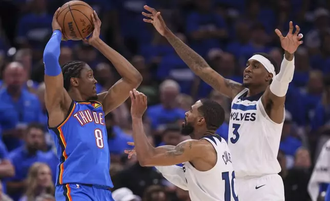 Oklahoma City Thunder forward Jalen Williams (8) is defended by Minnesota Timberwolves guard Mike Conley (10) and forward Jaden McDaniels (3) during the second half of Game 2 of an NBA basketball Western Conference Finals playoff series Thursday, May 22, 2025, in Oklahoma City. (AP Photo/Nate Billings)