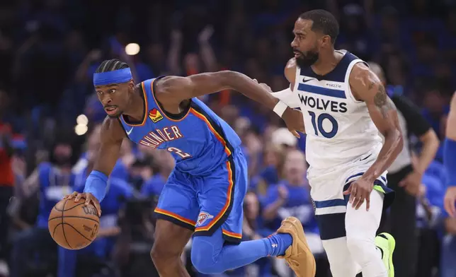 Oklahoma City Thunder guard Shai Gilgeous-Alexander (2) drives against Minnesota Timberwolves guard Mike Conley (10) during the first half of Game 2 of an NBA basketball Western Conference Finals playoff series Thursday, May 22, 2025, in Oklahoma City. (AP Photo/Nate Billings)