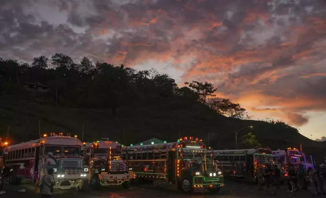A woman stands on a bus during a Red Devils tuning exhibition in Chilibre, Panama, Sunday, May 4, 2025. The Red Devils are former U.S. school buses once used in the Panama Canal Zone and later repurposed as public transport or for private and cultural use. (AP Photo/Matias Delacroix)