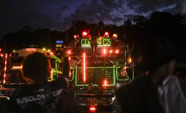 A woman stands on a bus during Red Devils running exhibition in Chilibre, Panama, Sunday, May 4, 2025. (AP Photo/Matias Delacroix)