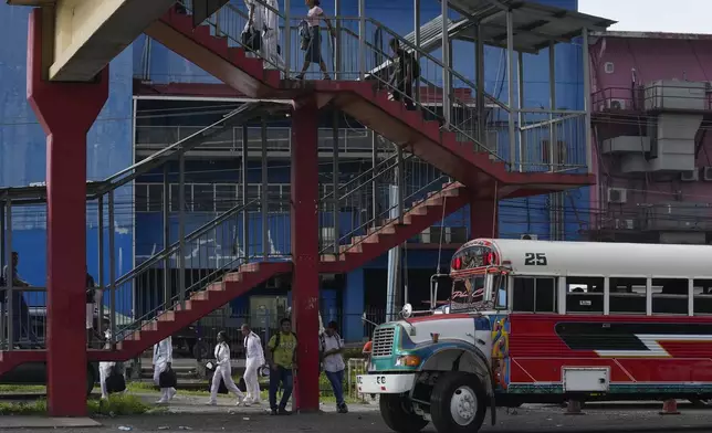 A Red Devil transport bus makes a stop in Colon, Panama, Friday, May 16, 2025. The Red Devils are former U.S. school buses once used in the Panama Canal Zone and later as public transport or adapted for private and cultural use. (AP Photo/Matias Delacroix)