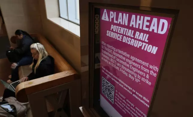 An electronic display advises commuters of potential NJ Transit service disruptions at the Secaucus Junction station in Secaucus, N.J., Wednesday, May 14, 2025. (AP Photo/Seth Wenig)
