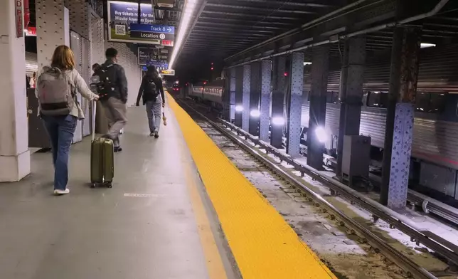 Amtrak passengers arrive at Penn Station in New York, Friday, May 16, 2025. (AP Photo/Richard Drew)